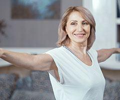Smiling woman with arms out